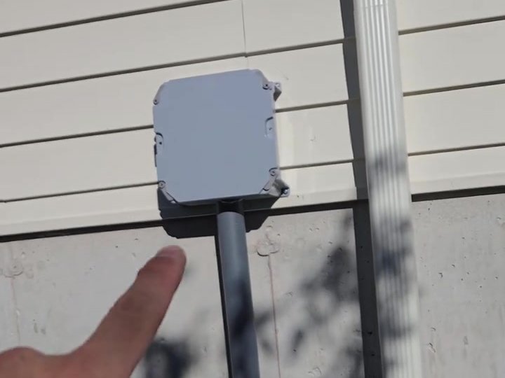 Low-voltage conduit and junction box roughed in on new-build siding