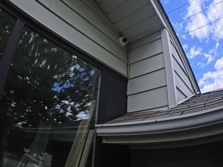 Security camera mounted under the eave of a Milton home with concealed wiring