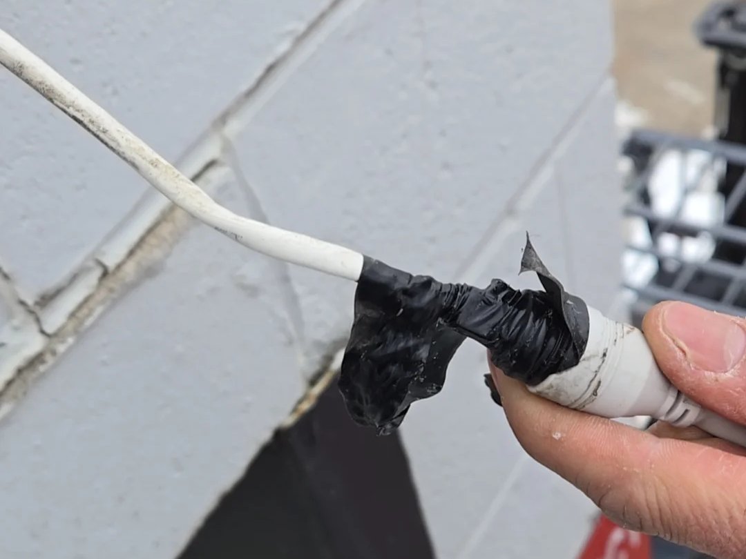 Taped camera cable connection found during a warehouse security upgrade