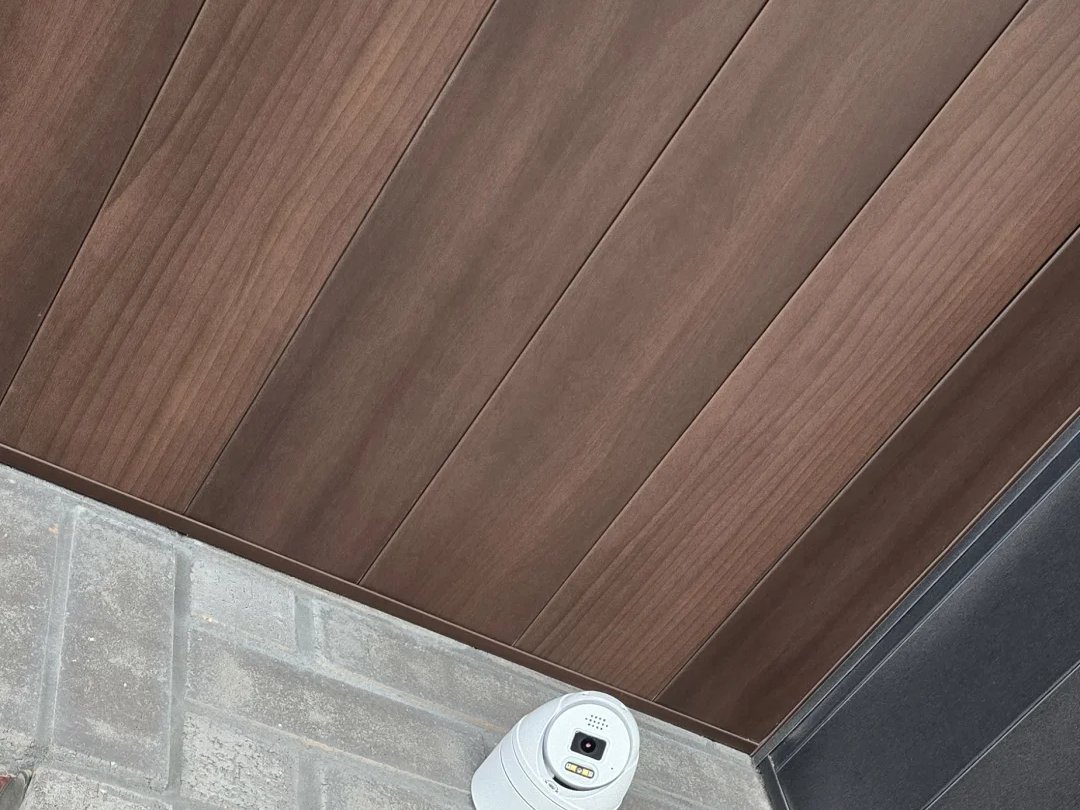 Security camera mounted on a wood soffit of a new Markham house