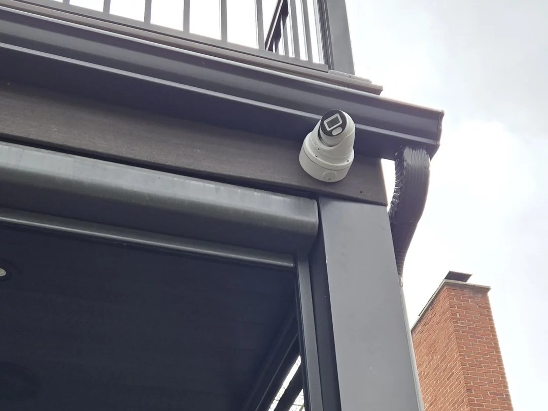 Security camera mounted under a balcony at a Midtown Toronto home