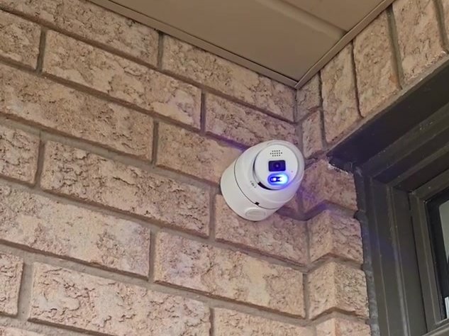 Security camera installed on beige brick at a Richmond Hill home